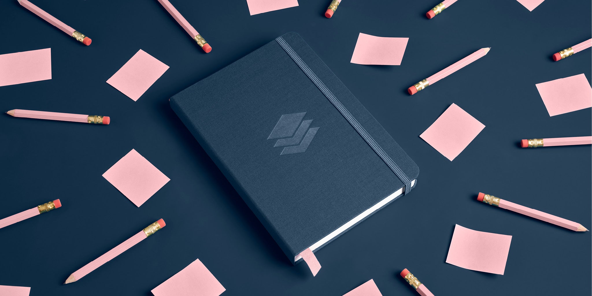 Draft Writing Journal on dark blue background with pink sticky notes and pink pencils