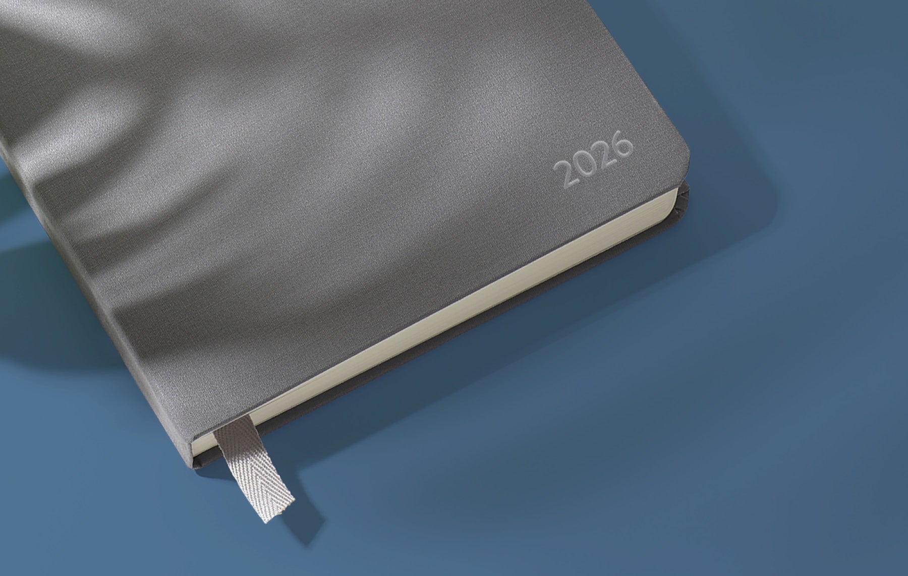 Gray cloth-covered planner with "2026" debossed on the cover.