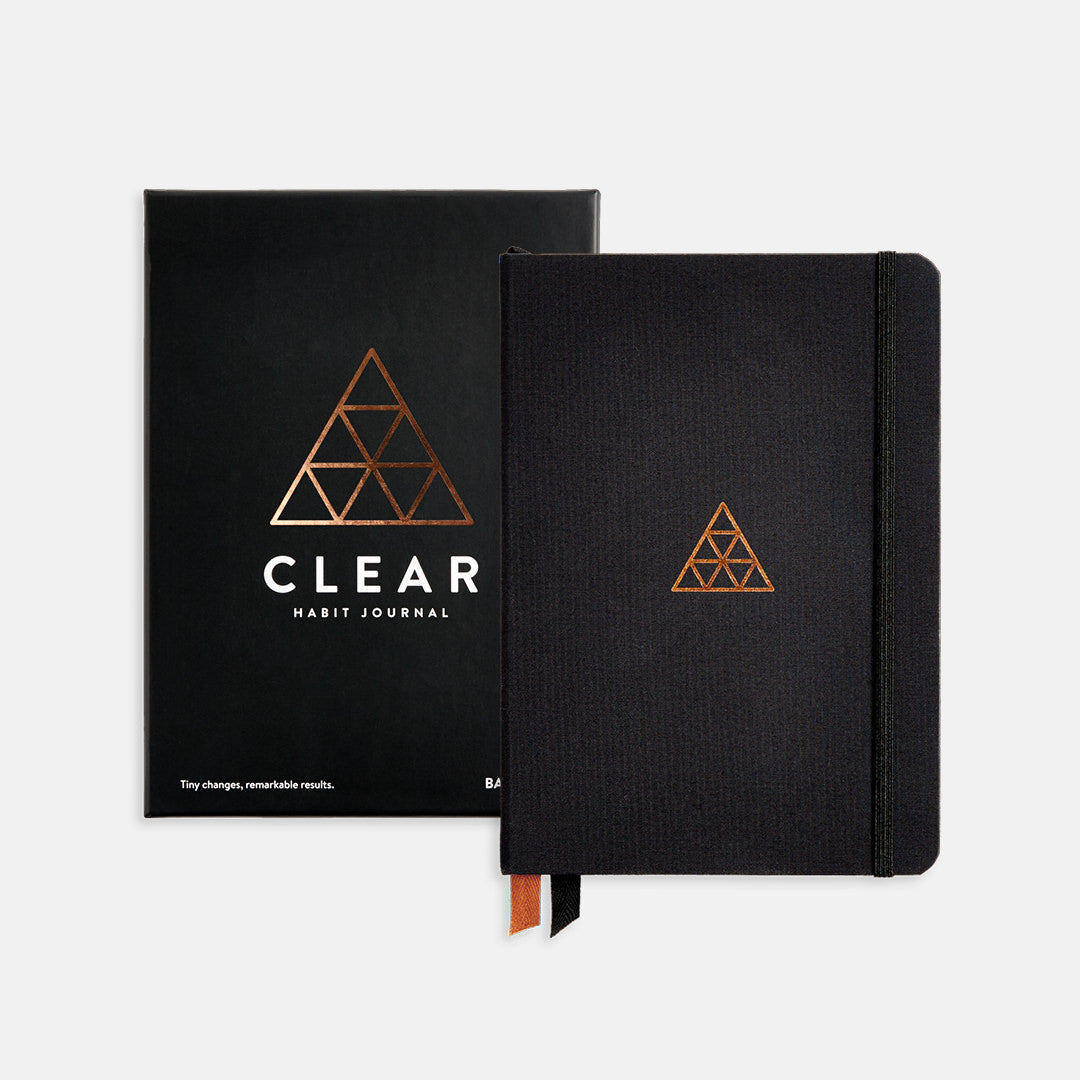 Closed black hardcover Clear Habit Journal with packaging.