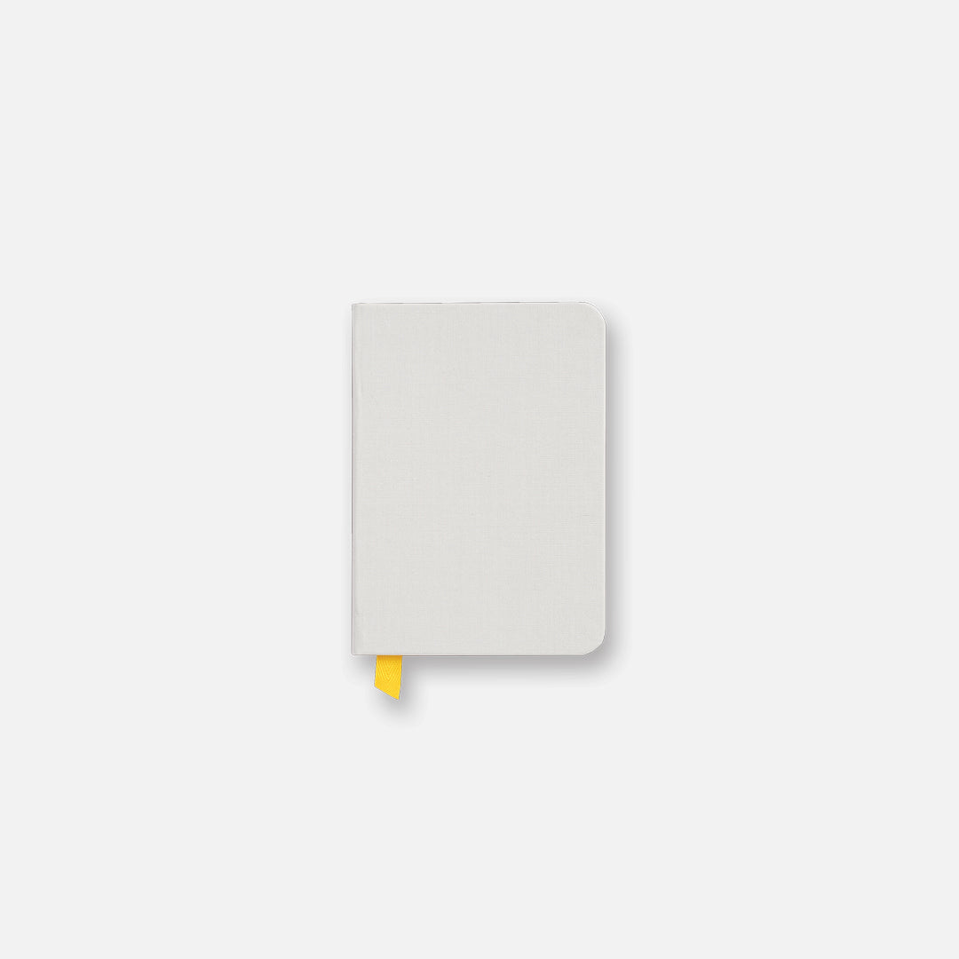 Pocket size light gray confidant hardcover notebook with yellow ribbon.