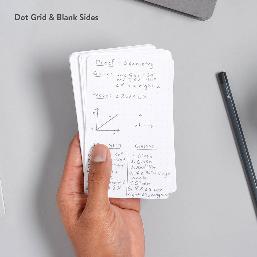 Hand holding strategist dot grid index cards with math diagrams